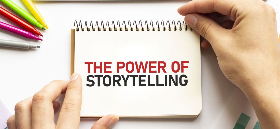 businesman hold notepad with text THE POWER OF STORYTELLING White background. Business